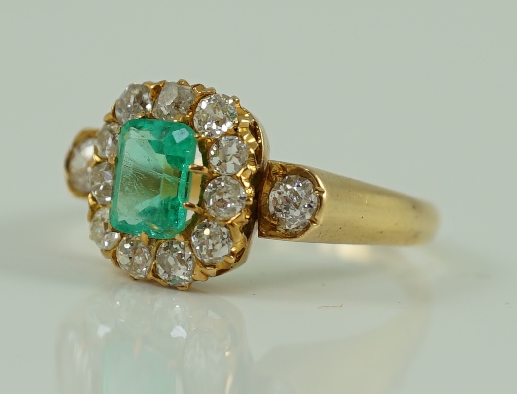 An 18ct gold, emerald and diamond octagonal cluster ring